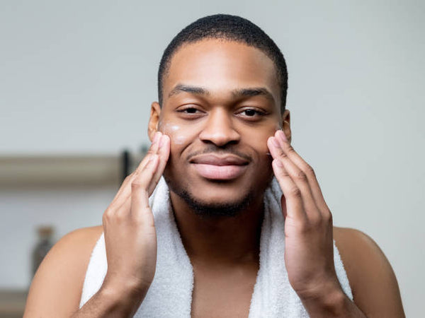 black man exfoliating skin
