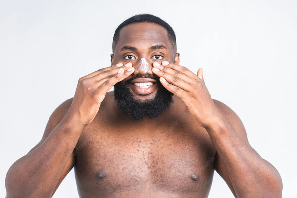 black man applying skin moisturiser