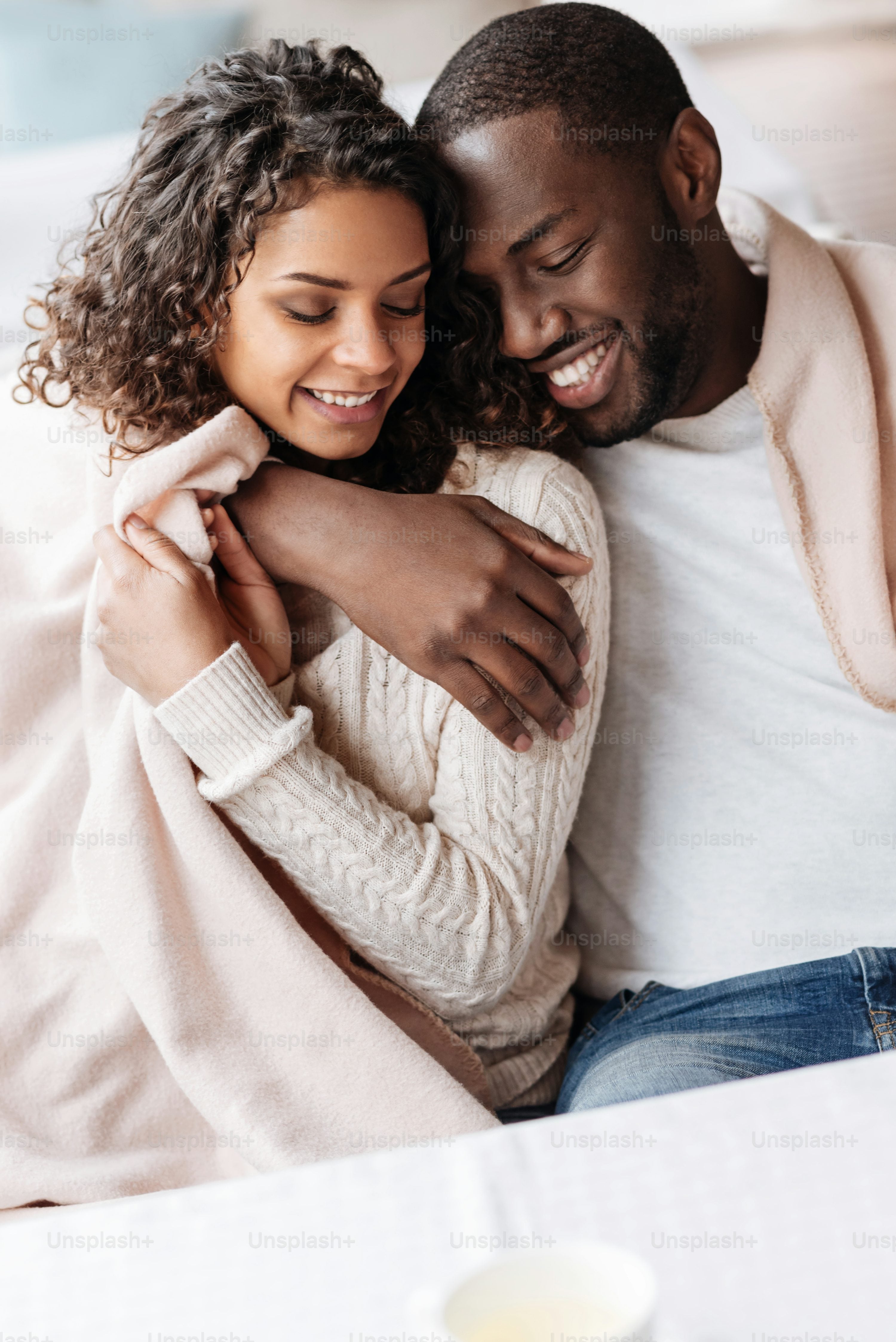 black man with black woman cuddling