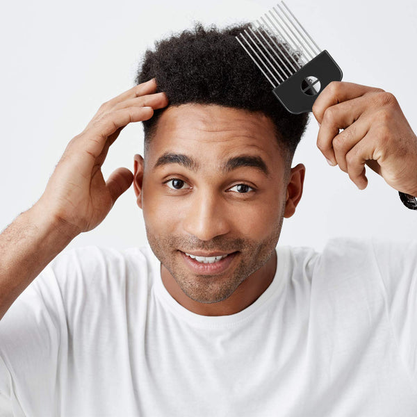 black man with afro comb brushing hair